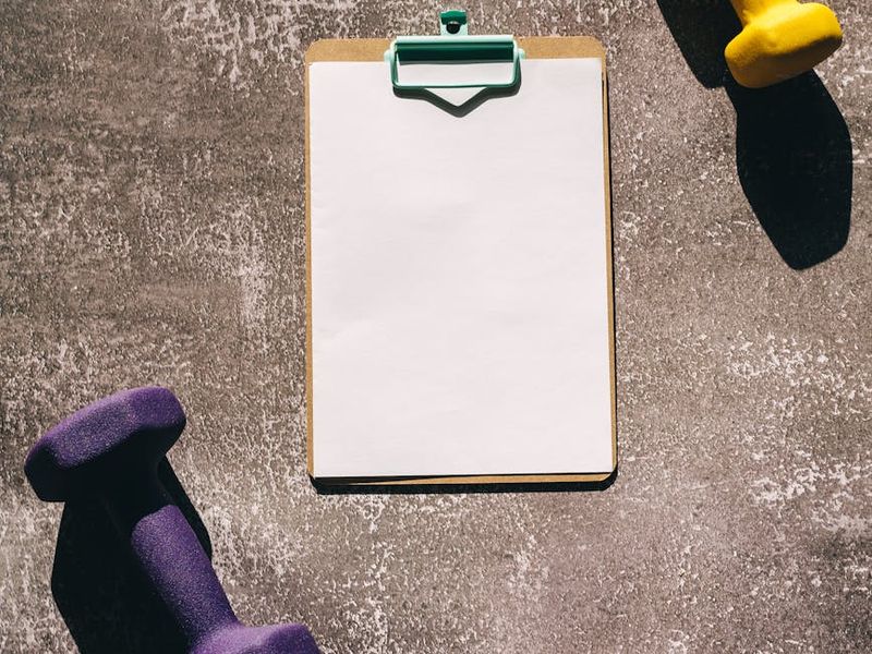 Detailed view of fitness equipment and structured training plan on a table